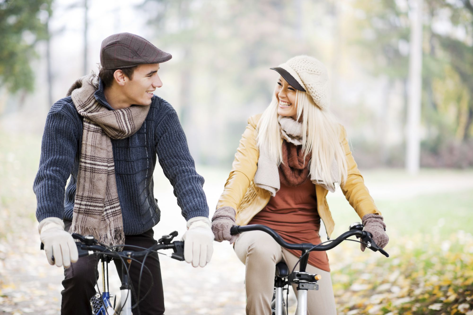 Beautiful day in the park, two young people riding bikes. [url=http://www.istockphoto.com/search/lightbox/9786786][img]http://dl.dropbox.com/u/40117171/couples.jpg[/img][/url]