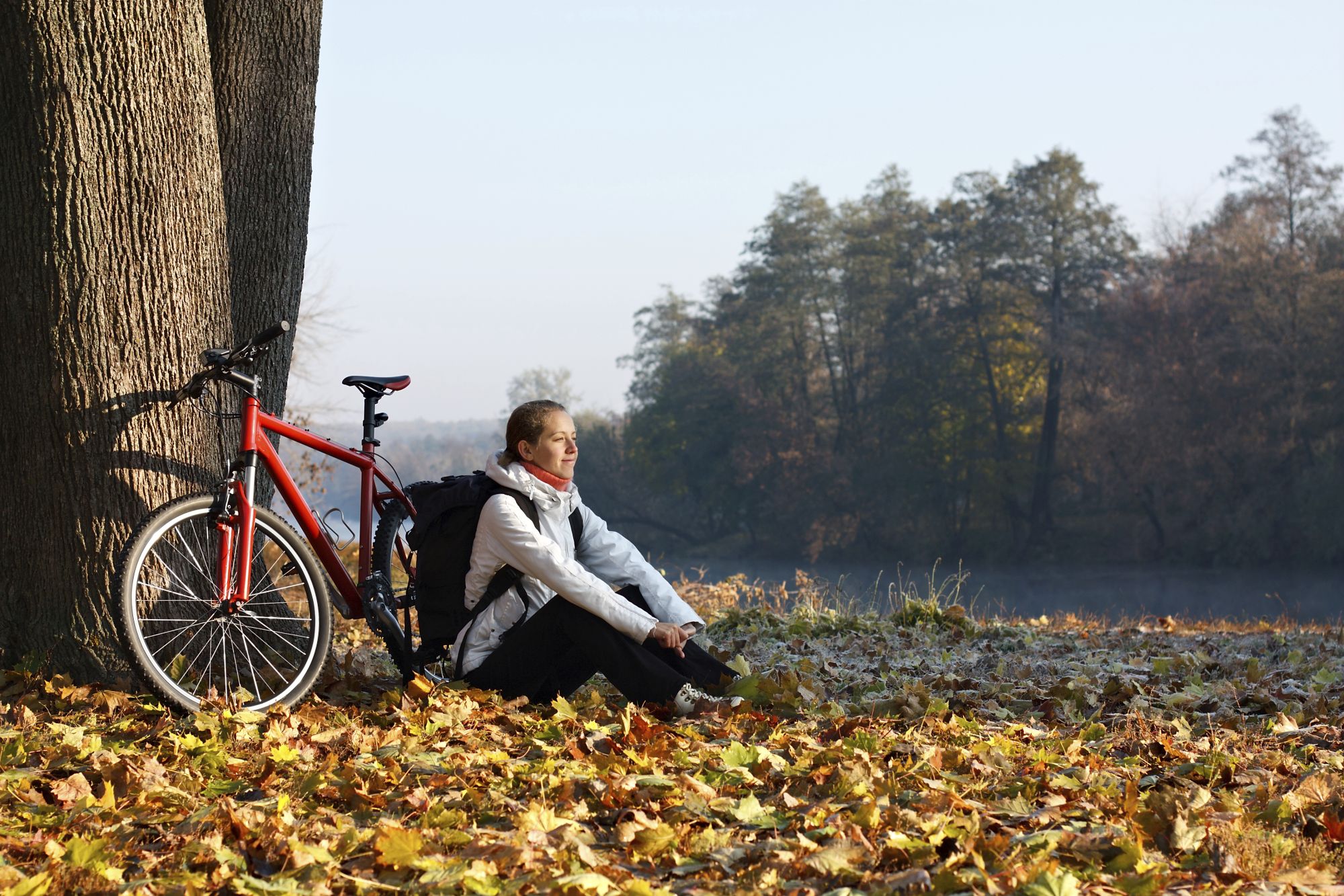 Peppy woman cyclist enjoy the recreation autumn morning in natur